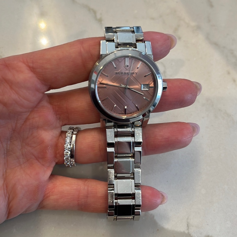 Stainless Steel Womans Burberry watch.  Pink face, comes with box, pillow, links